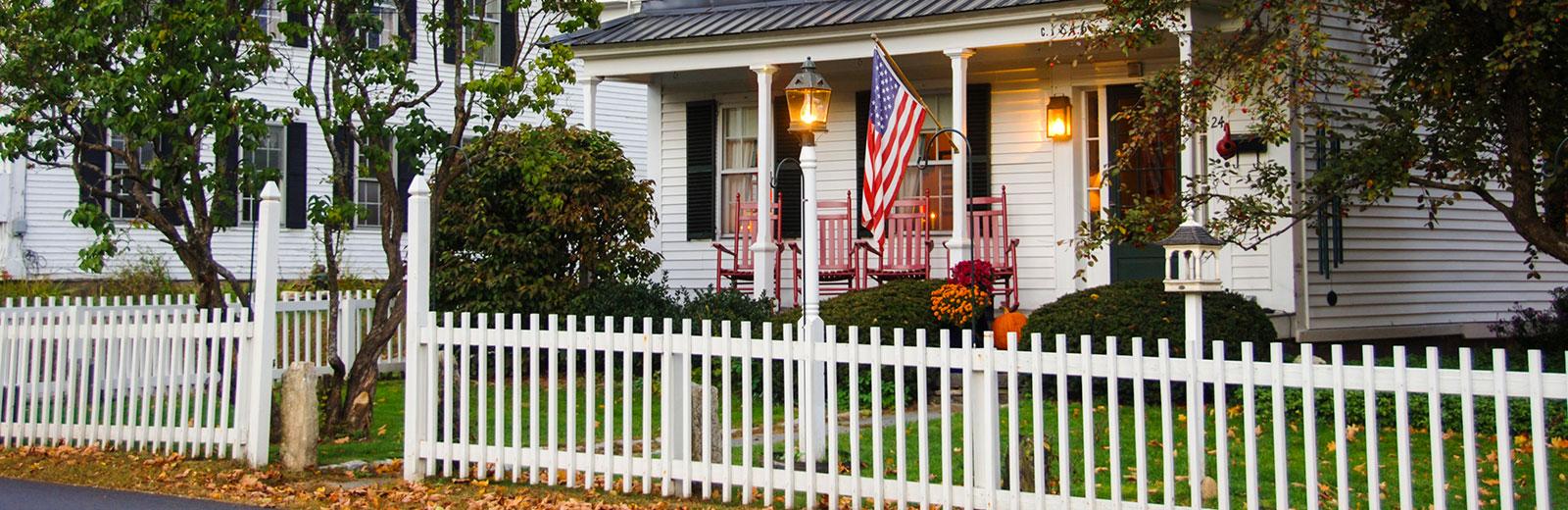 House with a white picket fence in the front yard 